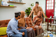 © Odua Images - visiting friend and family during eid mubarak islamic day. beautiful of muslim people talking at home