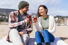 Content Couple Clinking Wineglasses On Beach