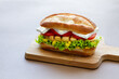 © ADDICTIVE STOCK - Delicious sandwich with chicken on cutting board