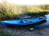 Fototapeta Miasto - Boat on a Lake Coast