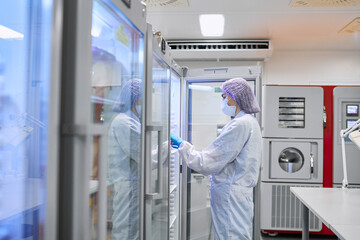 A girl scientist checks a sample for research