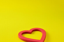 Wooden Object, In The Shape Of A Red Heart On An Intense Yellow Background. Concept Of Love, Not For A Specific Day, But For Every Day. Copy Space.