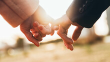 Closeup Image Of Two Lovers Holding Hands At Sunset - Trust, Love, Relationship And Support Concept