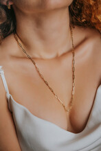 Close-up Young Woman Wearing White Sexy Satin Blouse And Gold Chain Necklace. Modern Fashion Details. Minimalist Lifestyle