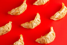 Background Of Pork Potstickers Dumplings On A Bright Red Background
