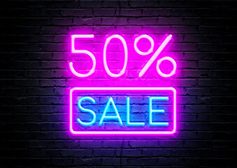 50% sale pink and blue neon sign with brick wall background.