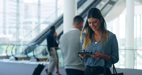 Poster - Working on the move. 4k video footage of an attractive young businesswoman using her tablet while walking through her office building.