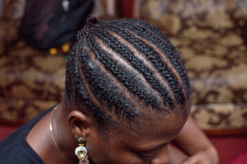 Front view of weave on hair style on the head of an African Nigerian female client