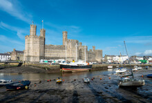 Caernarfon Castle And River Seiont At Low Tide,in Late Afternoon Sun,North Wales,United Kingdom.