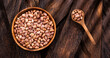 Phaseolus vulgaris - Dried pinto beans in the bowl and wooden spoon