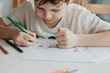 © Ekaterina - The boy draws with pencils at the kitchen