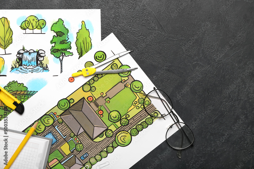 Paper sheets with sketches for landscape design and stationery on dark background