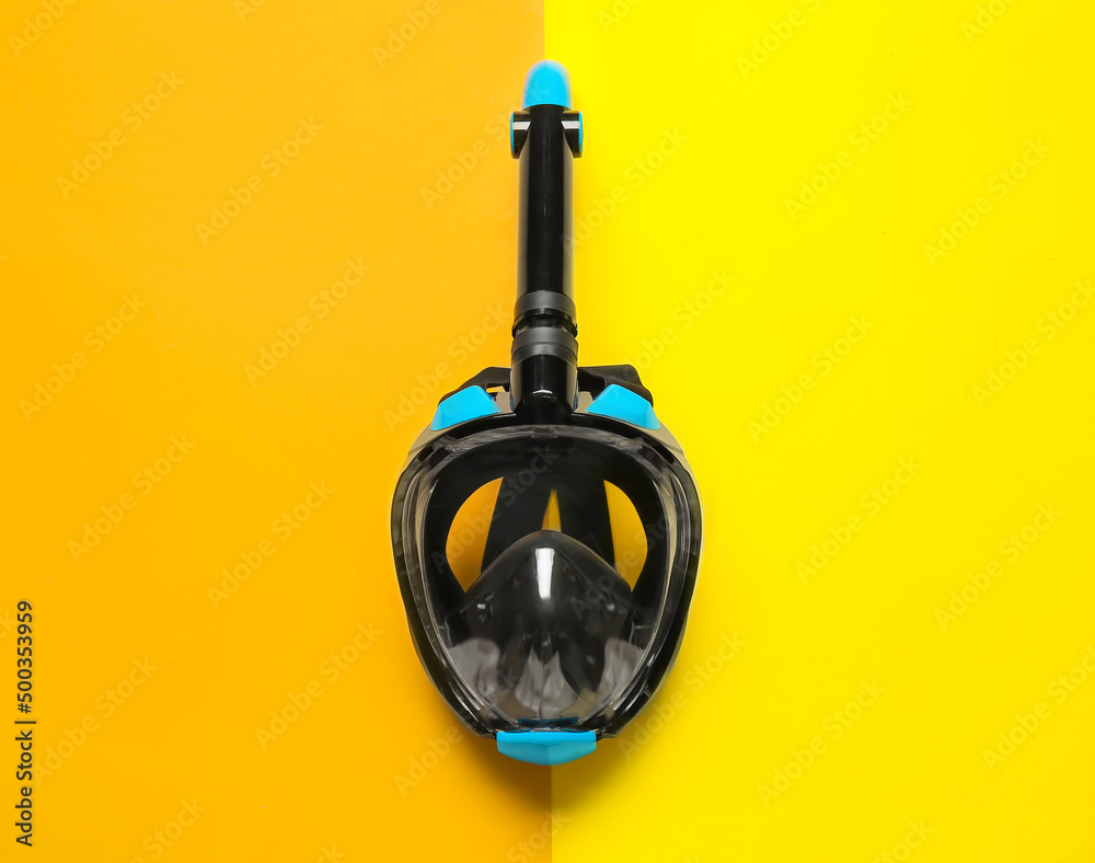 Modern snorkeling mask on color background