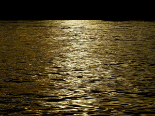 Canvas Print - gold water wave in the river with reflection of sunlight at sunset