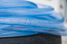 Condensed Water Droplets In A Clear Blue Hose.