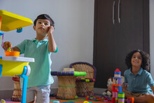 Children Playing With Toys In Living Room