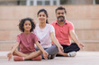 © IndiaPix - Portrait of happy family meditating together at outdoor in the morning