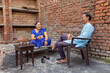 © IndiaPix - Senior couple talking to each other while having tea in the backyard