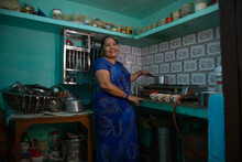 Senior Woman Making Tea In The Kitchen