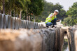© kamonrat - Woman construction site engineer architect worker with hard hat using tablet for checking concret pipes