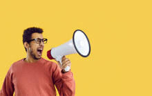 Man Shouting In Megaphone. Funny Guy Yelling In Loudspeaker Makes Important Announcement, Studio Portrait. Creative College Or University Student Inviting Talented Actors To Drama Club Play Audition