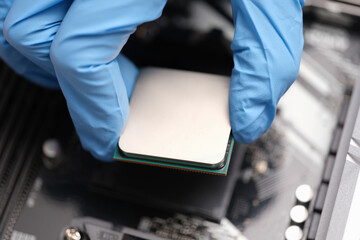 Sticker - Technician examines microprocessor chip on PC motherboard