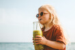 © EVERST - Child drinking smoothie outdoor healthy lifestyle summer vacations reusable glass bottle vegan beverage organic food