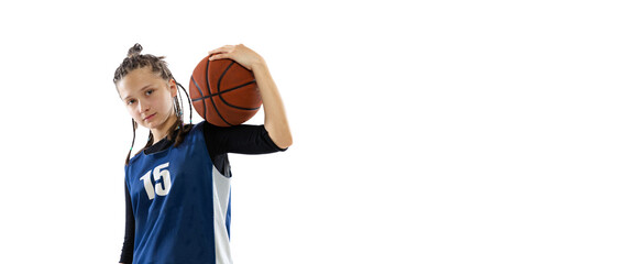 Portrait of teen girl, basketball player in uniform posing with ball on shoulder isolated over white studio background. Flyer