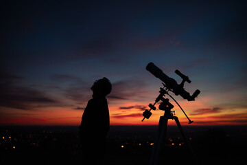 Wall Mural - silhouette of a man, telescope and countryside under the starry