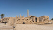 The ancient Karnak Temple in Luxor. Obelisks rise above the dilapidated stone walls. Clear blue sky. Copy space. Egypt