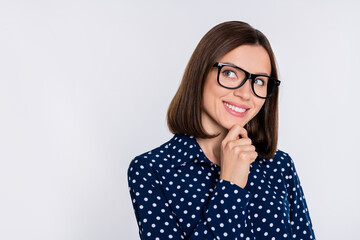 Poster - Photo of young cheerful woman arm touh chin look empty space curious think isolated over grey color background