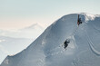 © fesenko - view of mountain slope covered with snow along which male skiers climb