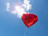 Fototapeta  - Heart-shaped balloon, red, against the blue sky..Copy space.