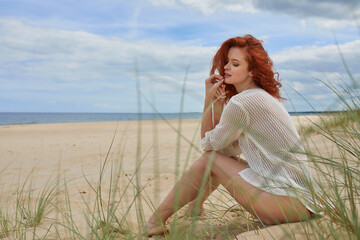 Wall Mural - Girl sunbathing on white sand beach