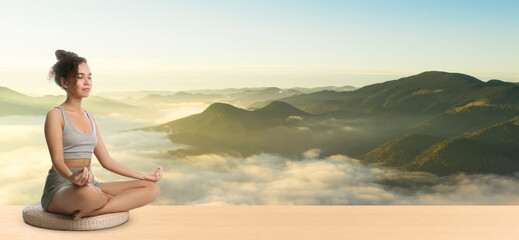 Wall Mural - Young African American woman practicing yoga on wooden surface against beautiful mountain landscape, space for text. Banner design