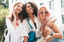 Three Young Beautiful Smiling Hipster Female In Trendy Summer Clothes.Sexy Carefree Multiracial Women Posing On The Street Background.Positive Models Having Fun In Sunglasses