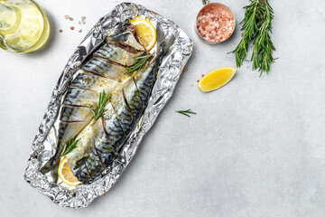 Wall Mural - marinated mackerel with spices and herbs ready for baking on a light background, Culinary, cooking concept. place for text, top view