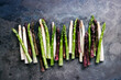 Leinwandbild Motiv Green, white and purple asparagus on a kitchen background