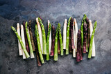 Fototapeta Łazienka - Green, white and purple asparagus on a kitchen background