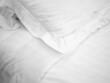 Closeup of wrinkle pillow and blanket on bed in bedroom for room service in hotel, housekeeping, homework preparing or allergy protection concept