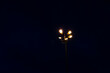 Bottom view single light tower illuminate the street at night.