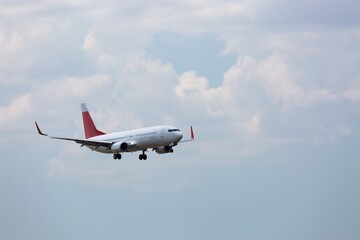 Canvas Print - Airplane flying above clouds in beautiful sky. Travel concept.