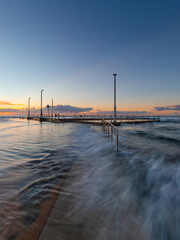 Wall Mural - high tide water flow around mona vale rock pool, sydney, australia.