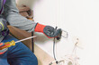 © fx-visual - male electrician fixing an electrical outlet