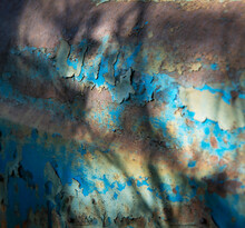 Tractor. At The Junkyard. Perished Agricultural History. Abandoned And Rusted Machinery.  Paintless And Weathered.