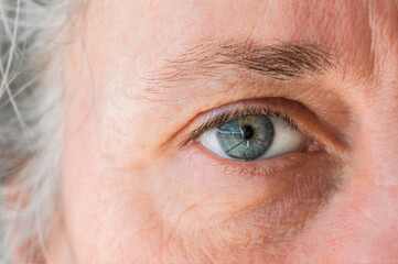 close up of macro shot elderly man two brown eyes with pupil and iris