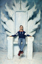 Child Sitting On Blue Throne