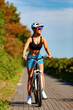 © Jacek Chabraszewski - Young woman riding bicycle