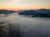 Fototapeta Góry - Sunrise over the fog in the Ukrainian Carpathians. Aerial drone view.