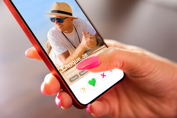 Woman using online dating app on her mobile phone